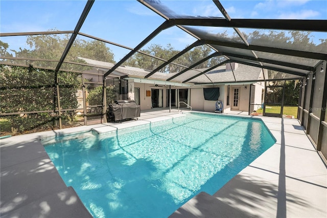 7410 Locksley Ln, Lakeland, FL 33809 - outdoor pool featuring a patio, grilling area, a ceiling fan, and glass enclosure
