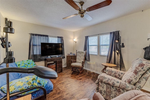 living room featuring hardwood / wood-style floors, a textured ceiling, and ceiling fan