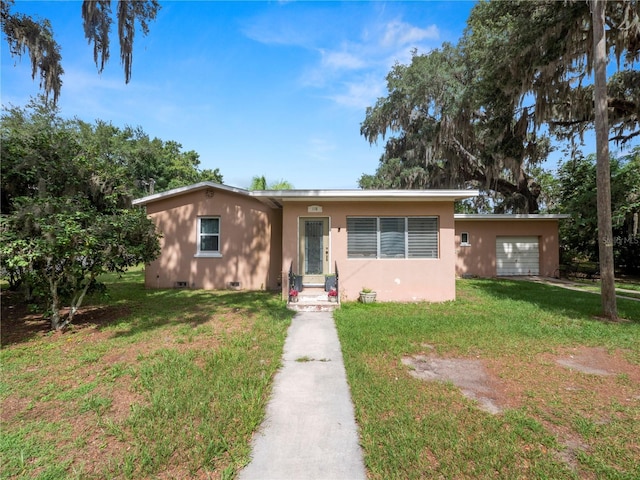 view of front of property featuring a front yard, crawl space, and an attached garage