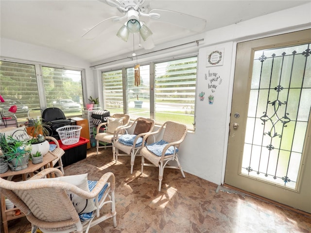 sunroom / solarium featuring lofted ceiling and ceiling fan