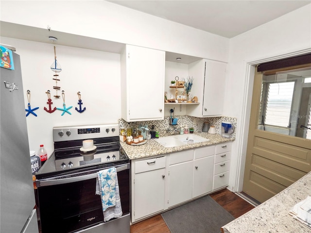 kitchen with stainless steel appliances, white cabinetry, a sink, and open shelves