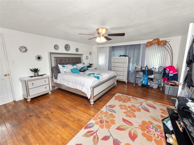 bedroom featuring wood-type flooring and a ceiling fan