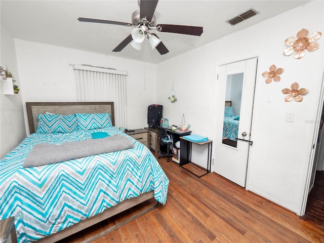 bedroom featuring visible vents, ceiling fan, and wood finished floors