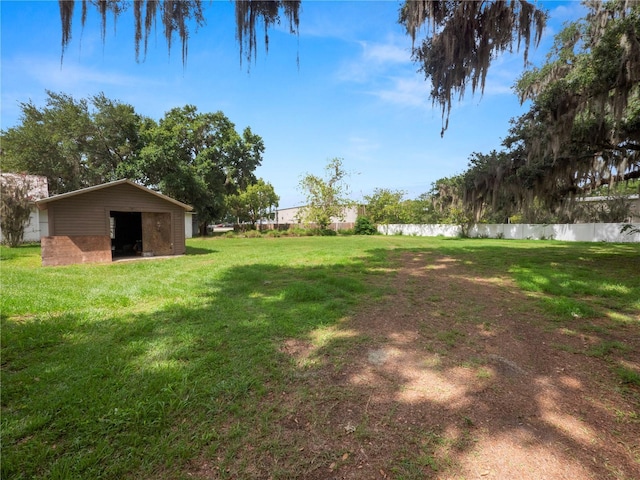 view of yard featuring fence and an outdoor structure