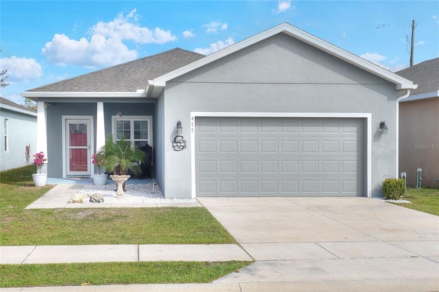 single story home featuring a garage and a front lawn