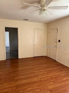 empty room featuring hardwood / wood-style floors and ceiling fan