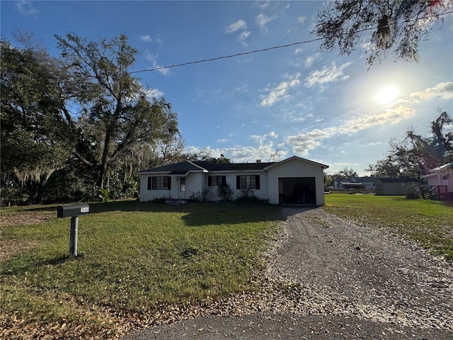 ranch-style house with a front lawn and a garage