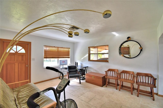 interior space with stone tile floors, visible vents, and baseboards