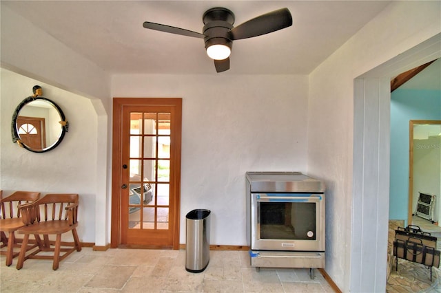 room details featuring stainless steel electric range oven and ceiling fan