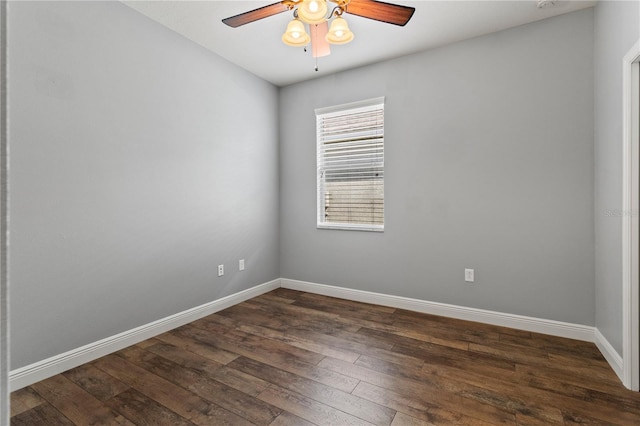 unfurnished room featuring dark wood finished floors, a ceiling fan, and baseboards