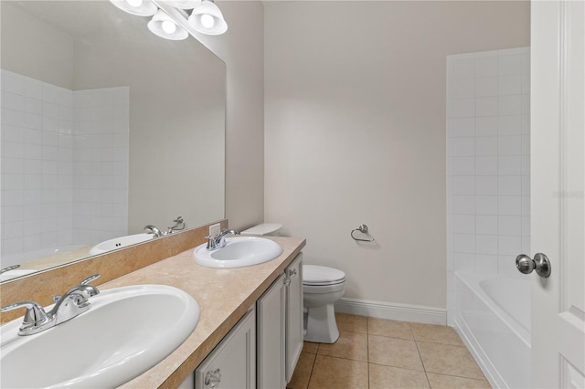 bathroom featuring tile patterned flooring, a sink, and baseboards