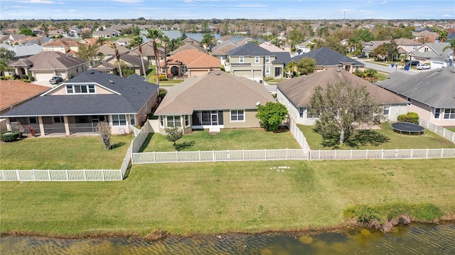 birds eye view of property with a water view and a residential view