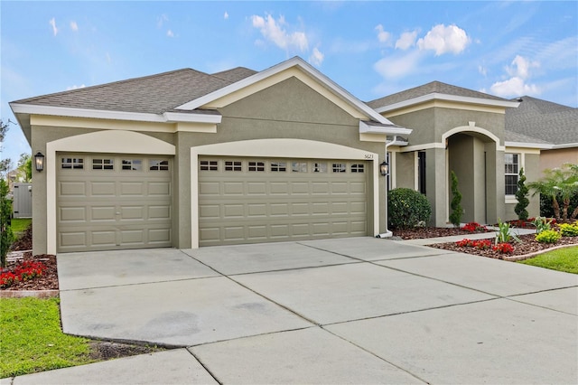 single story home featuring an attached garage, driveway, roof with shingles, and stucco siding