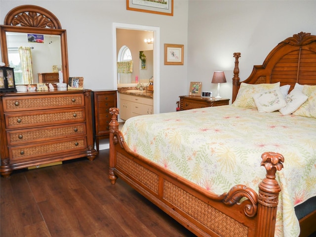 bedroom featuring connected bathroom and dark wood finished floors