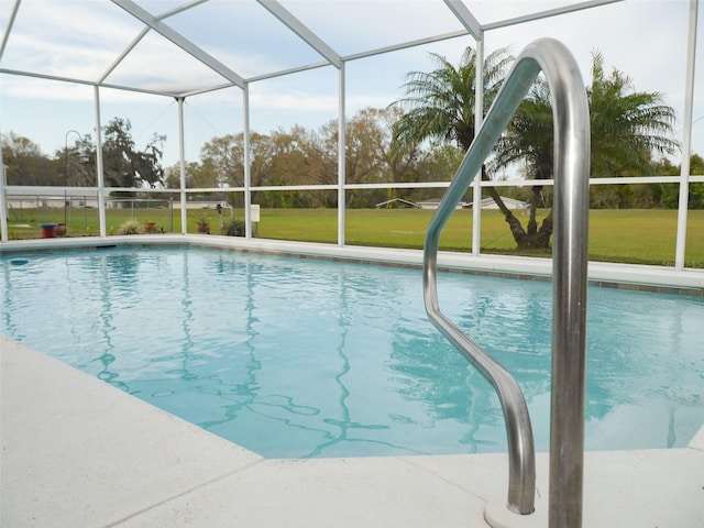 outdoor pool with a lanai and a lawn