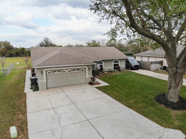 ranch-style house with concrete driveway, a front lawn, a shingled roof, and stucco siding