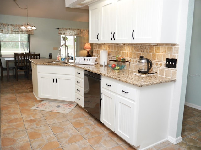 kitchen with black dishwasher, backsplash, white cabinets, a sink, and a peninsula