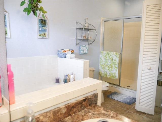 bathroom with toilet, a stall shower, and tile patterned floors