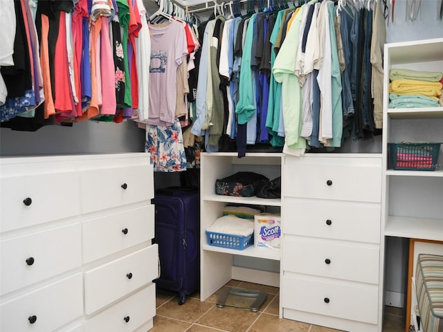 walk in closet with tile patterned floors