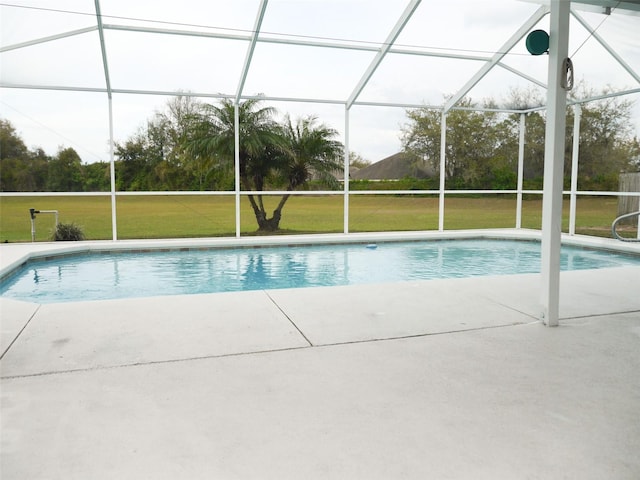 outdoor pool featuring a lanai, a lawn, and a patio