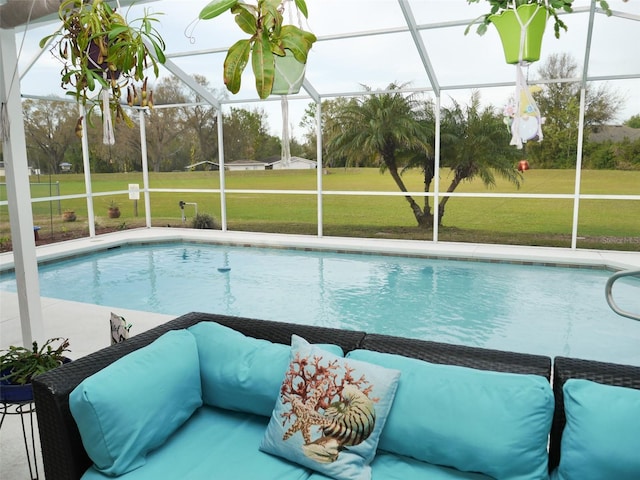 pool featuring a lawn, a patio area, and a lanai