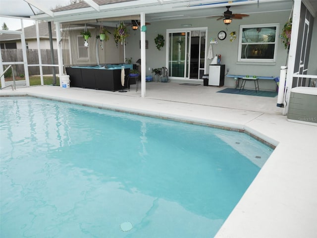 view of pool with a fenced in pool, a patio area, glass enclosure, ceiling fan, and fence