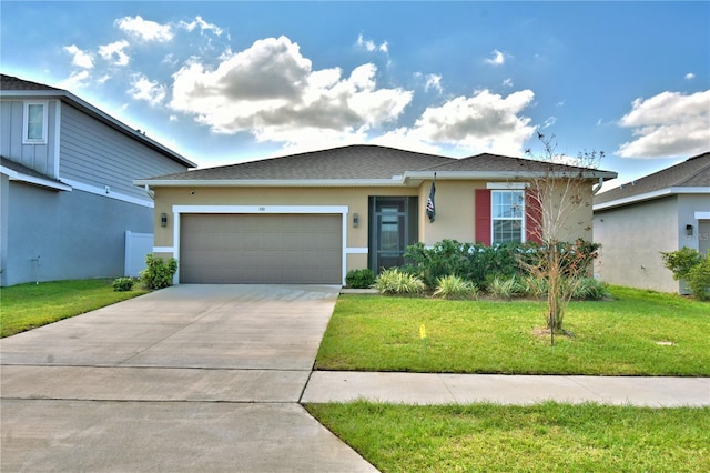 view of front of house featuring a garage and a front lawn