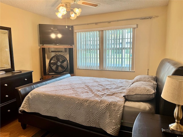 bedroom with hardwood / wood-style flooring and a textured ceiling