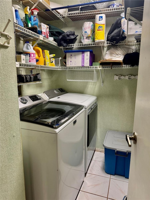 laundry area featuring separate washer and dryer and light tile patterned floors