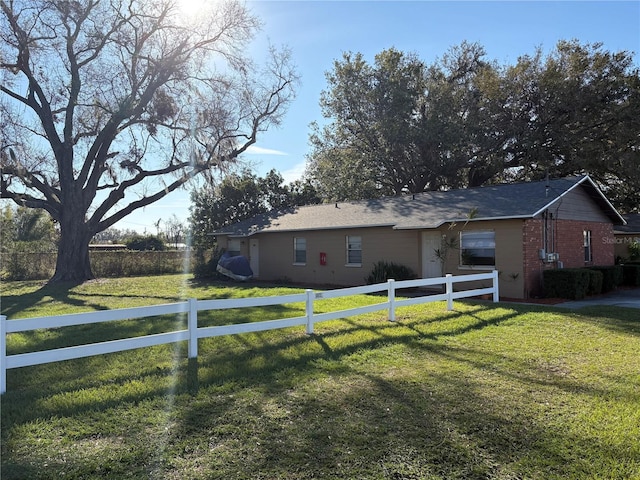 view of front of home with a fenced front yard and a front lawn