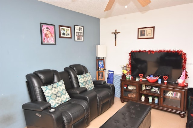 living room with ceiling fan and a textured ceiling