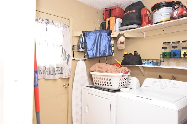 laundry area featuring a textured ceiling, laundry area, and separate washer and dryer