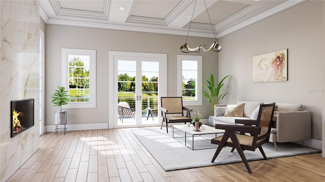 sitting room with light wood-style floors, ornamental molding, coffered ceiling, and french doors