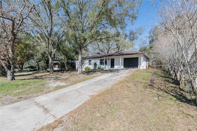 ranch-style home with a garage and a front lawn