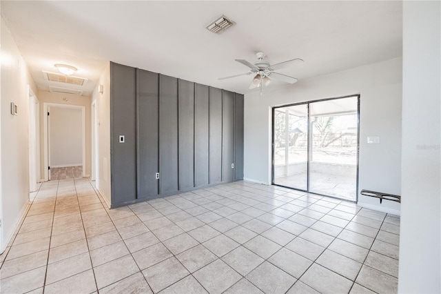 tiled spare room with ceiling fan