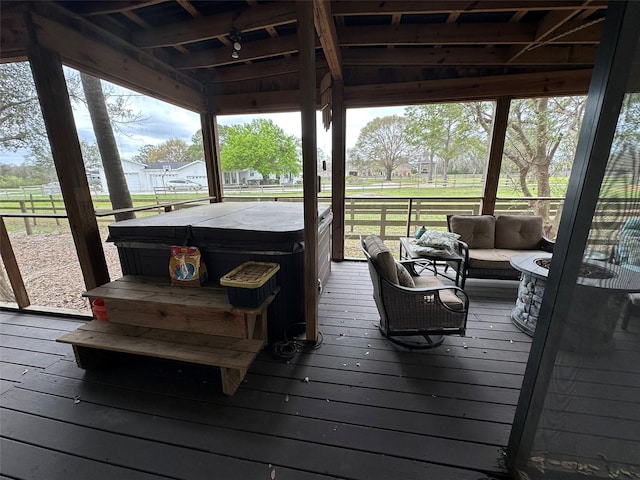 wooden terrace with outdoor lounge area and a hot tub