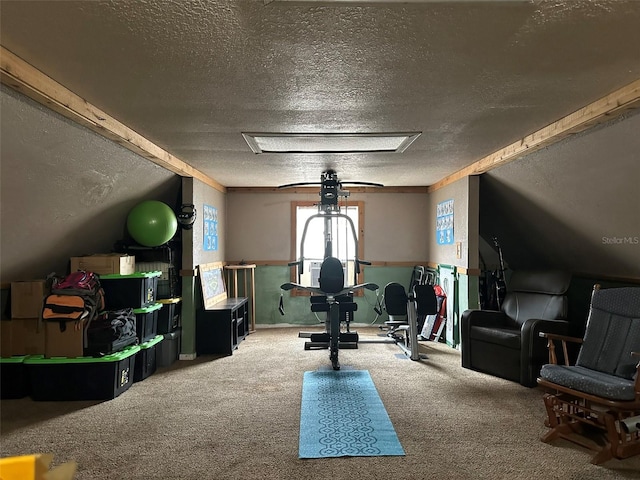 exercise room featuring carpet and a textured ceiling