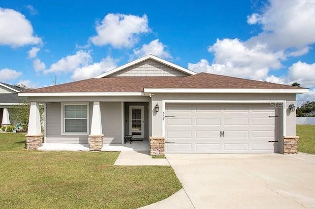 view of front of house with a porch, a garage, and a front yard