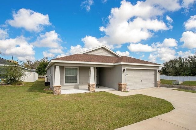 view of front of property with a garage, a front yard, and covered porch