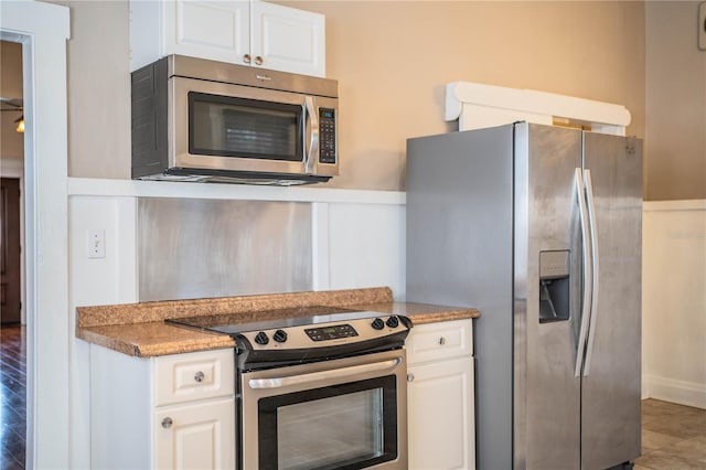 kitchen featuring white cabinetry and appliances with stainless steel finishes