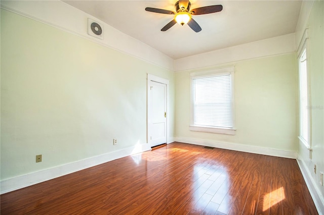 unfurnished room featuring ceiling fan, wood-type flooring, and plenty of natural light