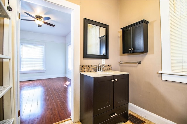 bathroom with ceiling fan, vanity, and hardwood / wood-style floors