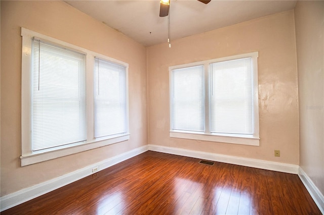 empty room with hardwood / wood-style flooring and ceiling fan