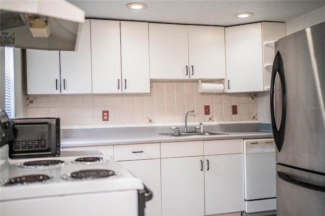 kitchen featuring white appliances, range hood, sink, and white cabinets