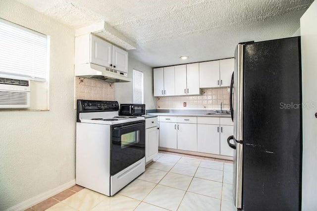 kitchen featuring white cabinetry, stainless steel fridge, sink, and electric range