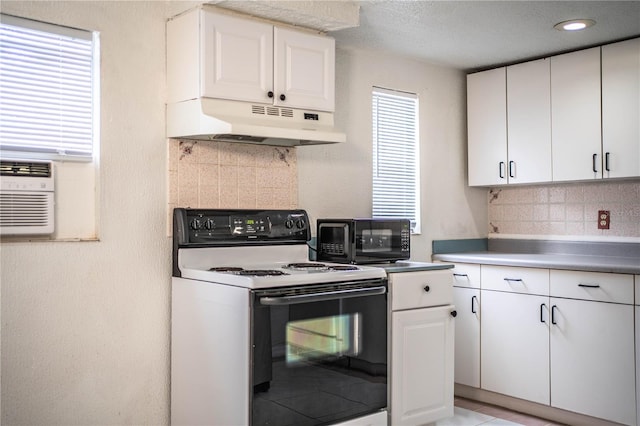 kitchen with white cabinetry, decorative backsplash, and range with electric cooktop