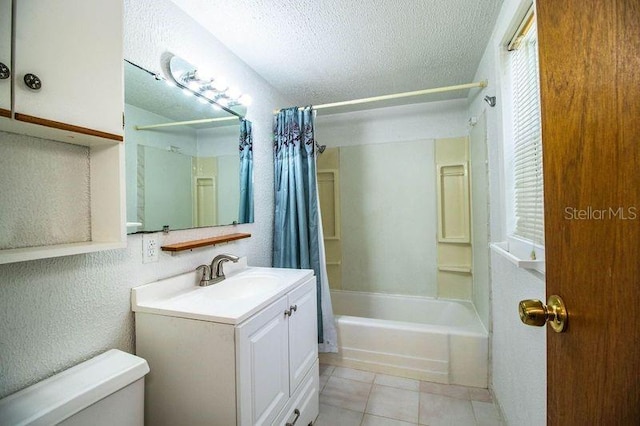 full bathroom featuring vanity, toilet, shower / bathtub combination with curtain, tile patterned floors, and a textured ceiling