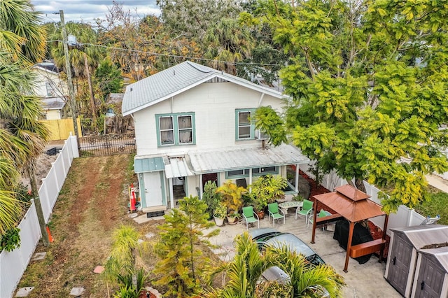 exterior space featuring a gazebo, a storage unit, and a patio