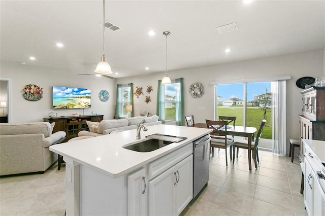 kitchen featuring white cabinetry, a center island with sink, hanging light fixtures, sink, and stainless steel dishwasher