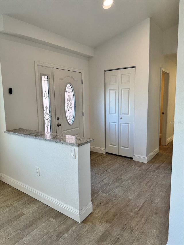 entryway with light wood-style floors and baseboards